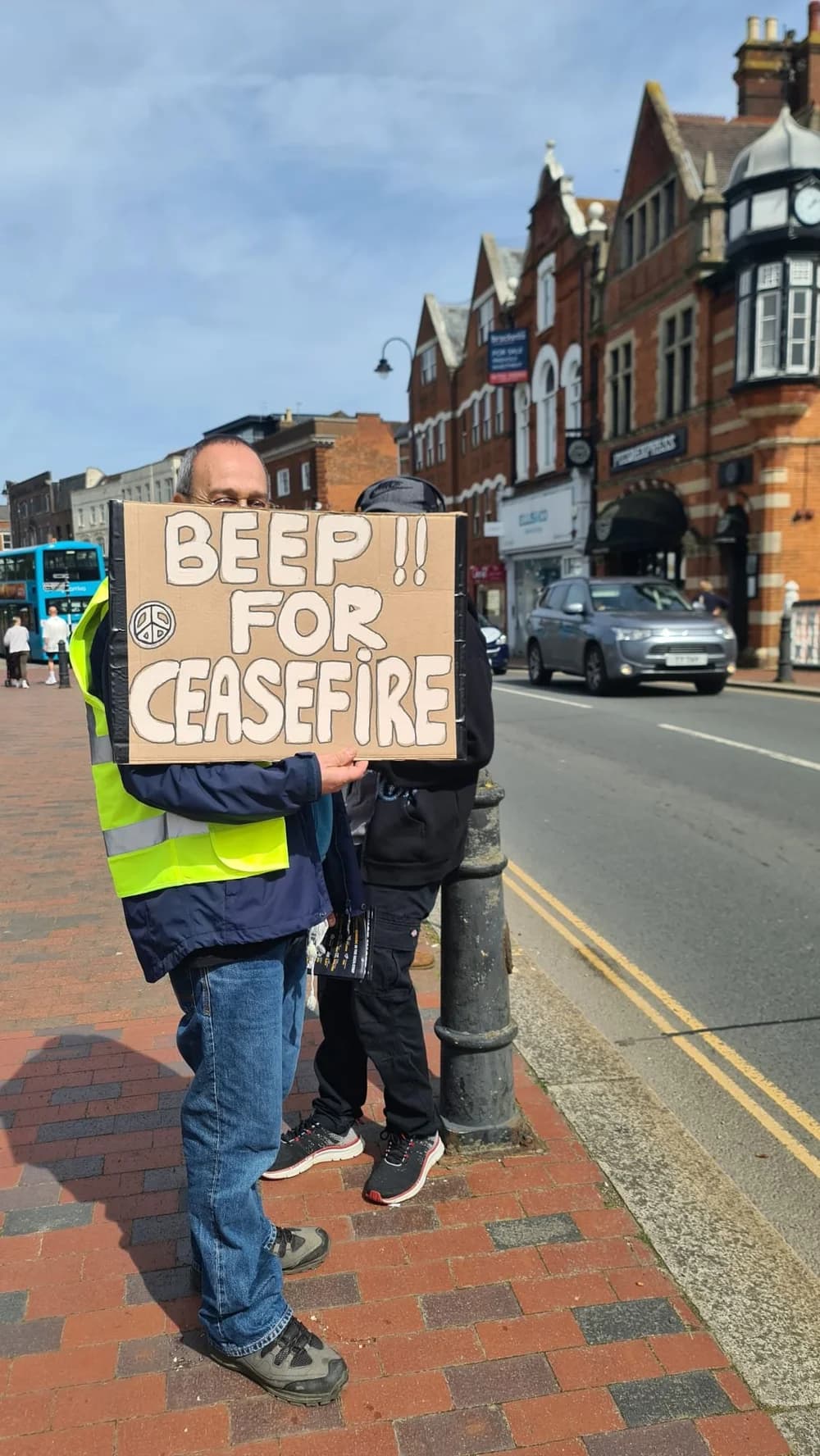 West Kent PSC supporter holding a Beep for Ceasefire sign